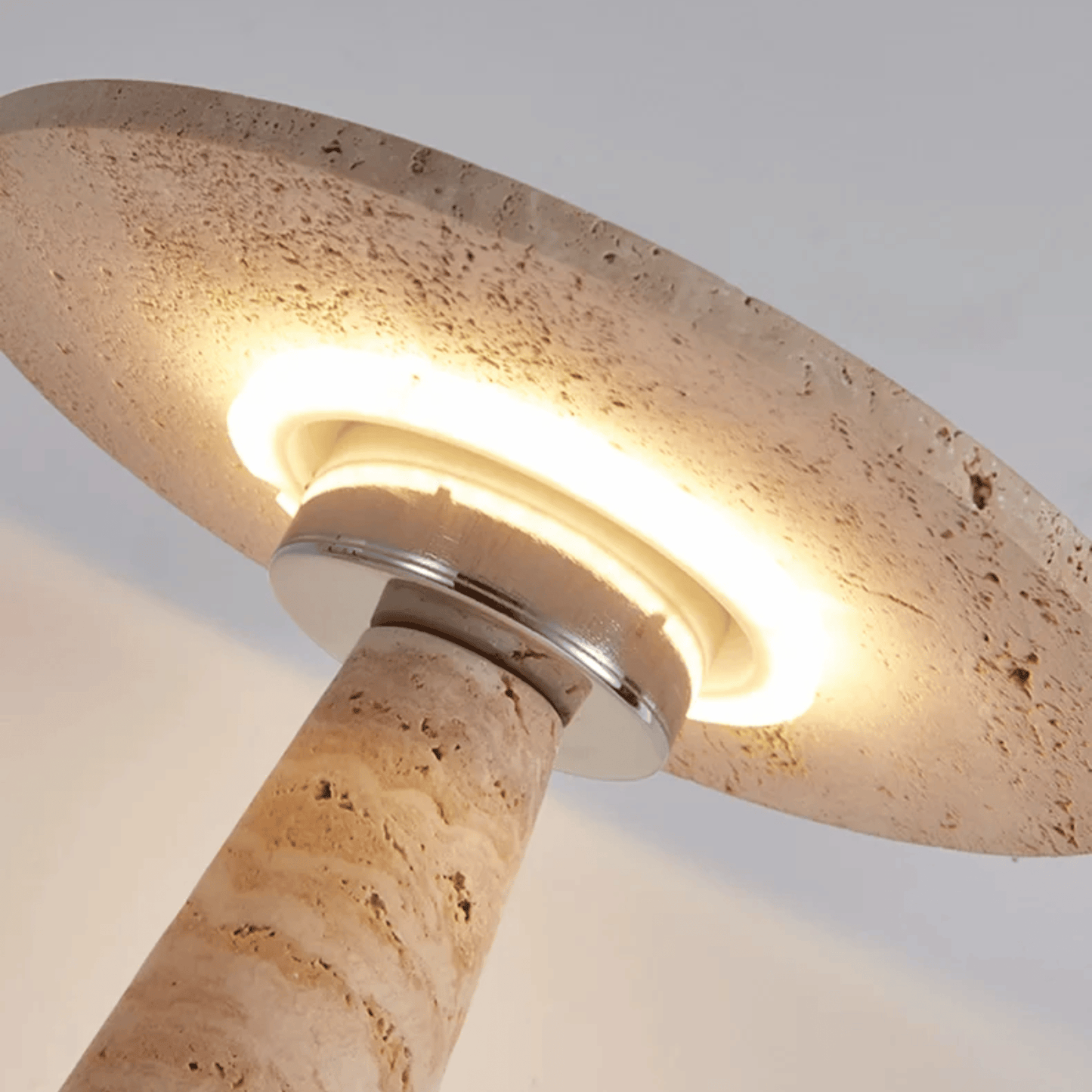 Beige stone lamp with a light fixture on a neutral background
