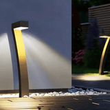 Modern outdoor garden light fixture illuminating a pathway at night.