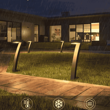 Modern outdoor setting with decorative lights on a house exterior during rain.