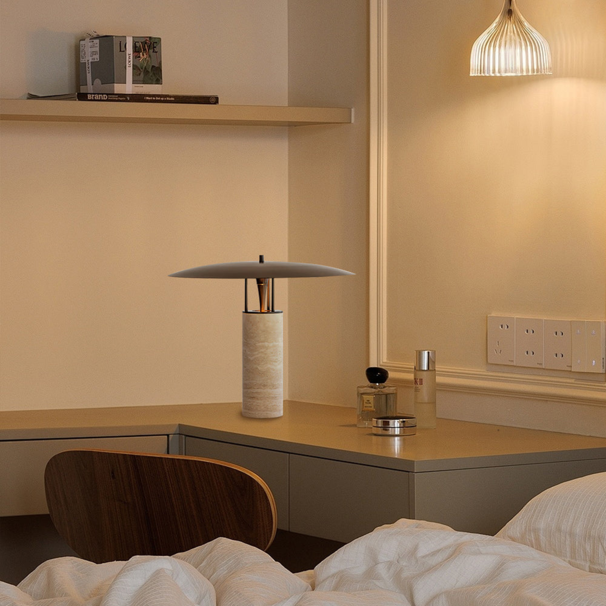 Cozy bedroom corner with a bamboo table lamp on a wooden side shelf casting warm light