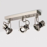 Three adjustable ceiling-mounted spotlights on a rectangular base with warm lighting.