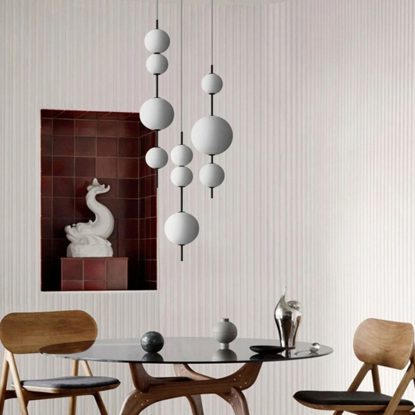 A close-up view of a cluster of three round pendant lights hanging from the ceiling in a contemporary interior.