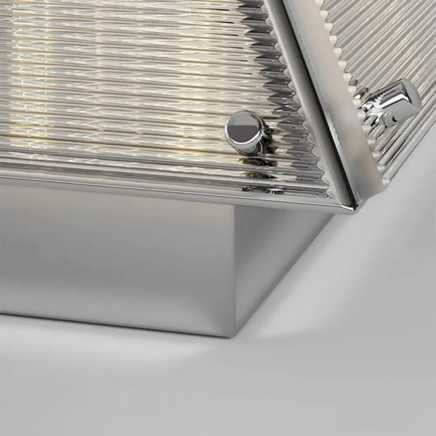 A close-up view of the lamp’s metallic base and pleated shade material.