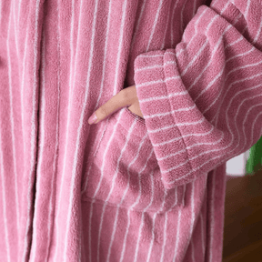 Close-up of a pink robe with white stripes worn by a person.
