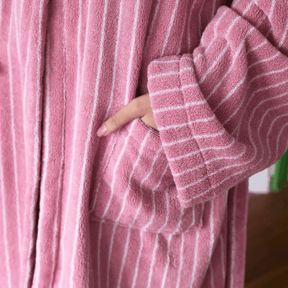 Close-up of a pink robe with white stripes worn by a person.