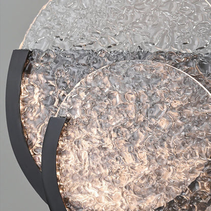 Close-up view of the textured glass surface showing irregular ripples and glowing light behind it.