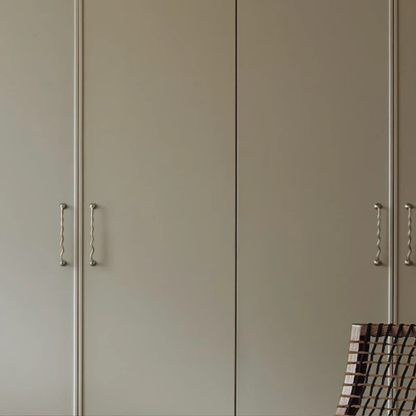 Tall wardrobe doors with matching wavy stainless steel handles