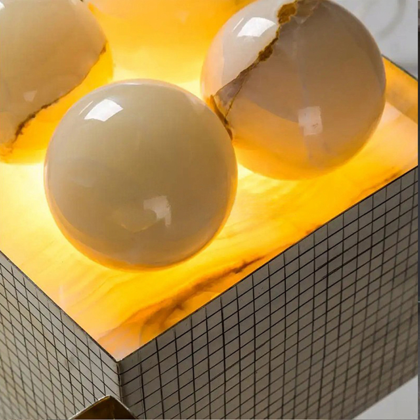 Three cracked eggs on a yellow surface with a tiled edge