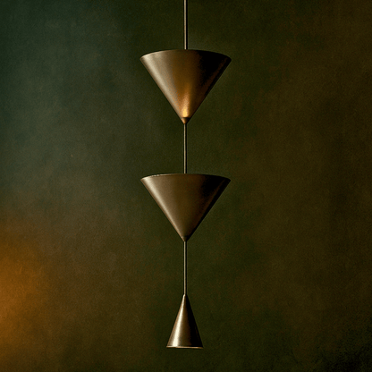 Bronze pendant light with three conical shades against a dark background