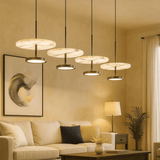 Modern living room with pendant lights, sofa, and decor elements.