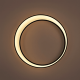 Circular wall light fixture on a brown background