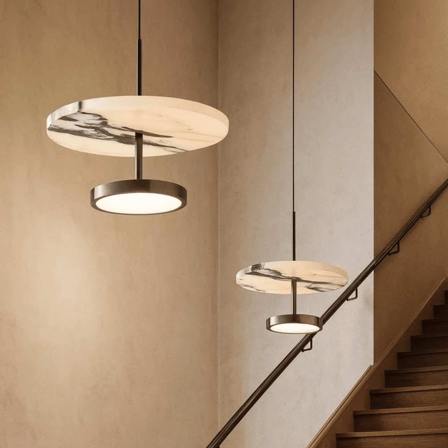 Modern pendant lights hanging above a staircase in a home interior.