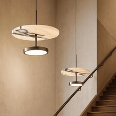 Modern pendant lights hanging above a staircase in a home interior.