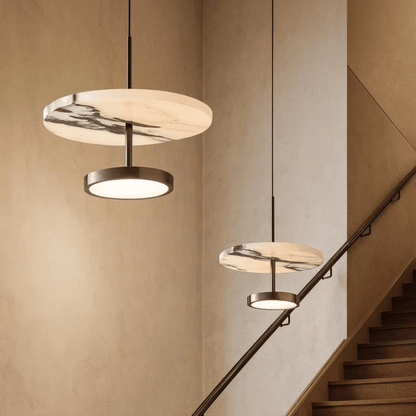 Modern pendant lights hanging above a staircase in a home interior.