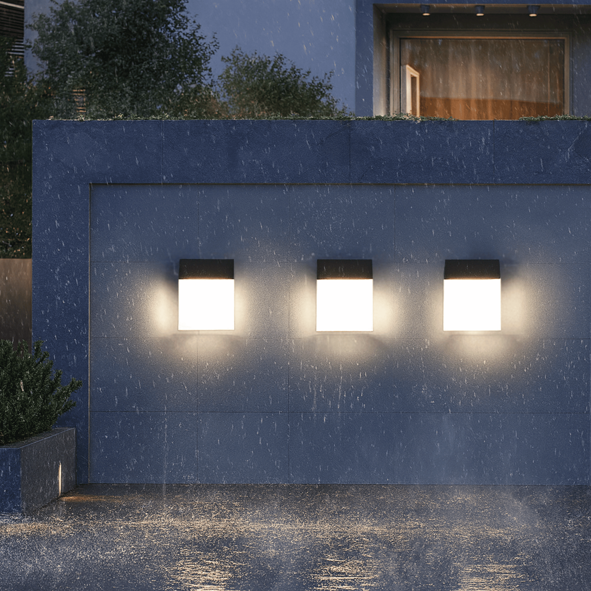 Three outdoor wall lights on a blue building facade with rain falling.