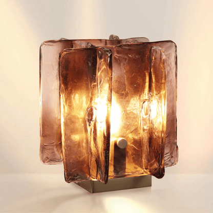 Glass table lamp with a textured design on a beige backround