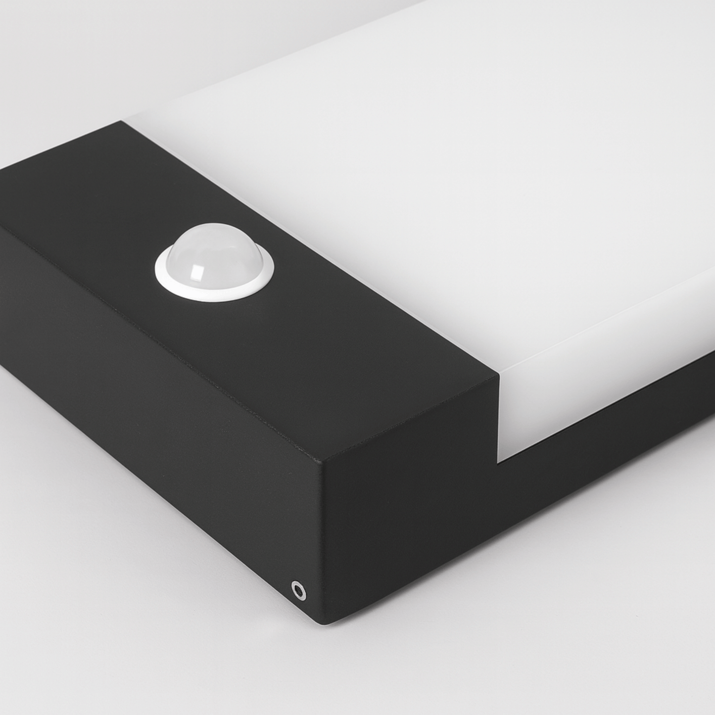 Black rectangular light fixture on a white background