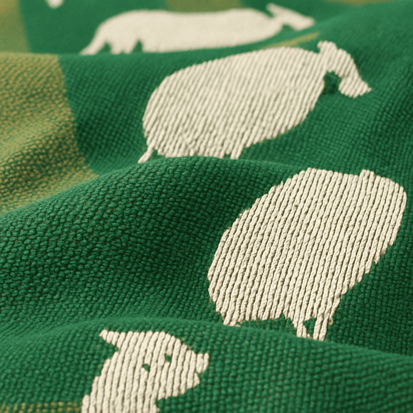Close-up of green fabric with white bear patterns
