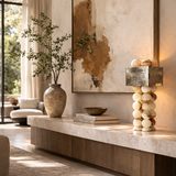 Living room with a stone shelf, lamp, and decorative items.