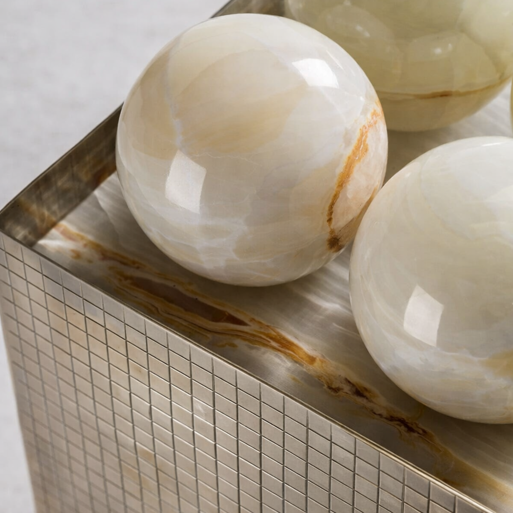Decorative onyx spheres on a mosaic tile surface