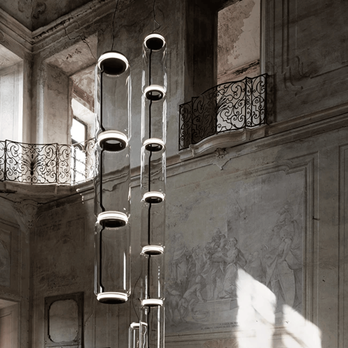 Modern chandelier hanging in an elegant interior setting with architectural details.
