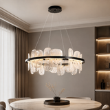 Modern chandelier hanging above a dining table in a stylish room.
