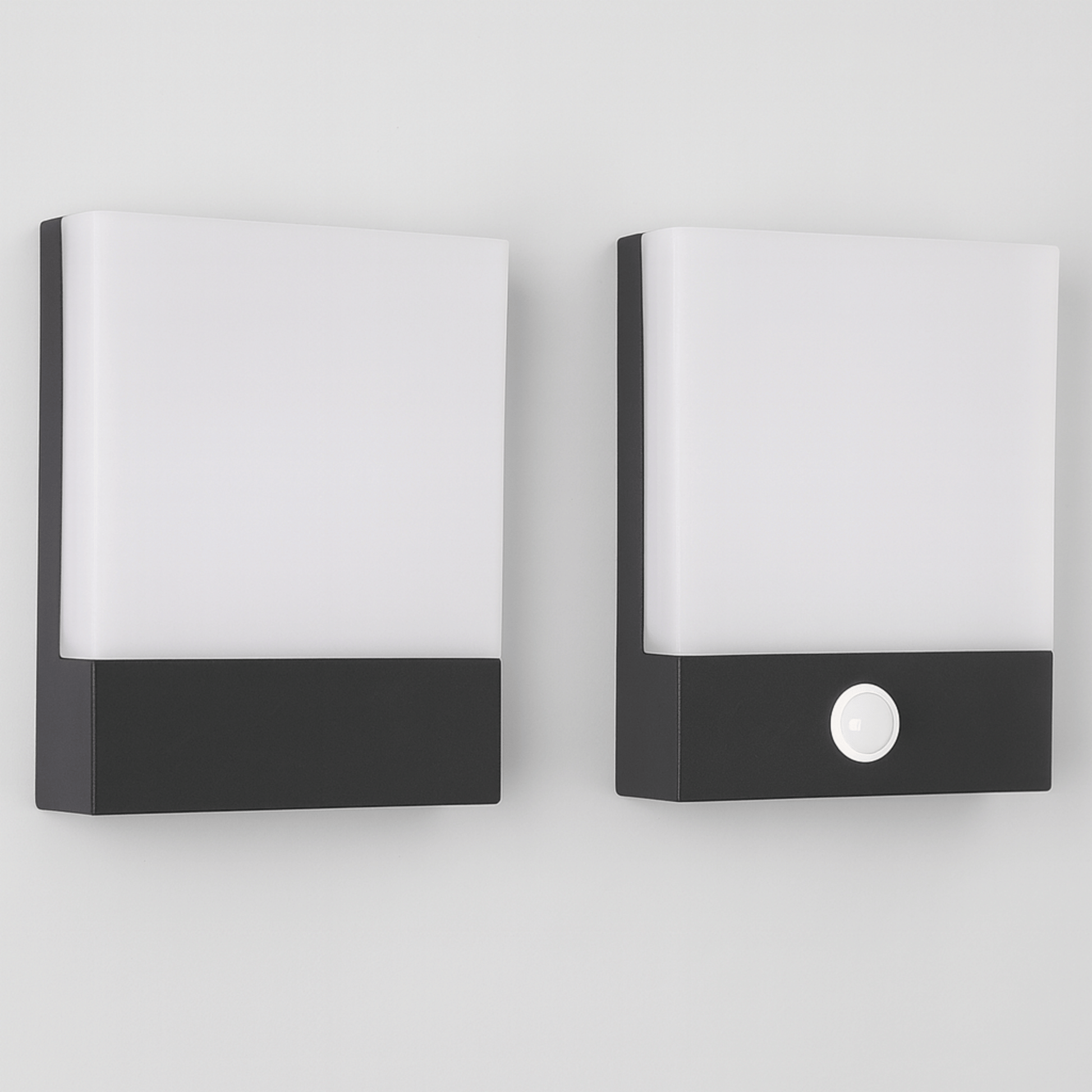 Two modern wall lights with black and white design on a light gray background