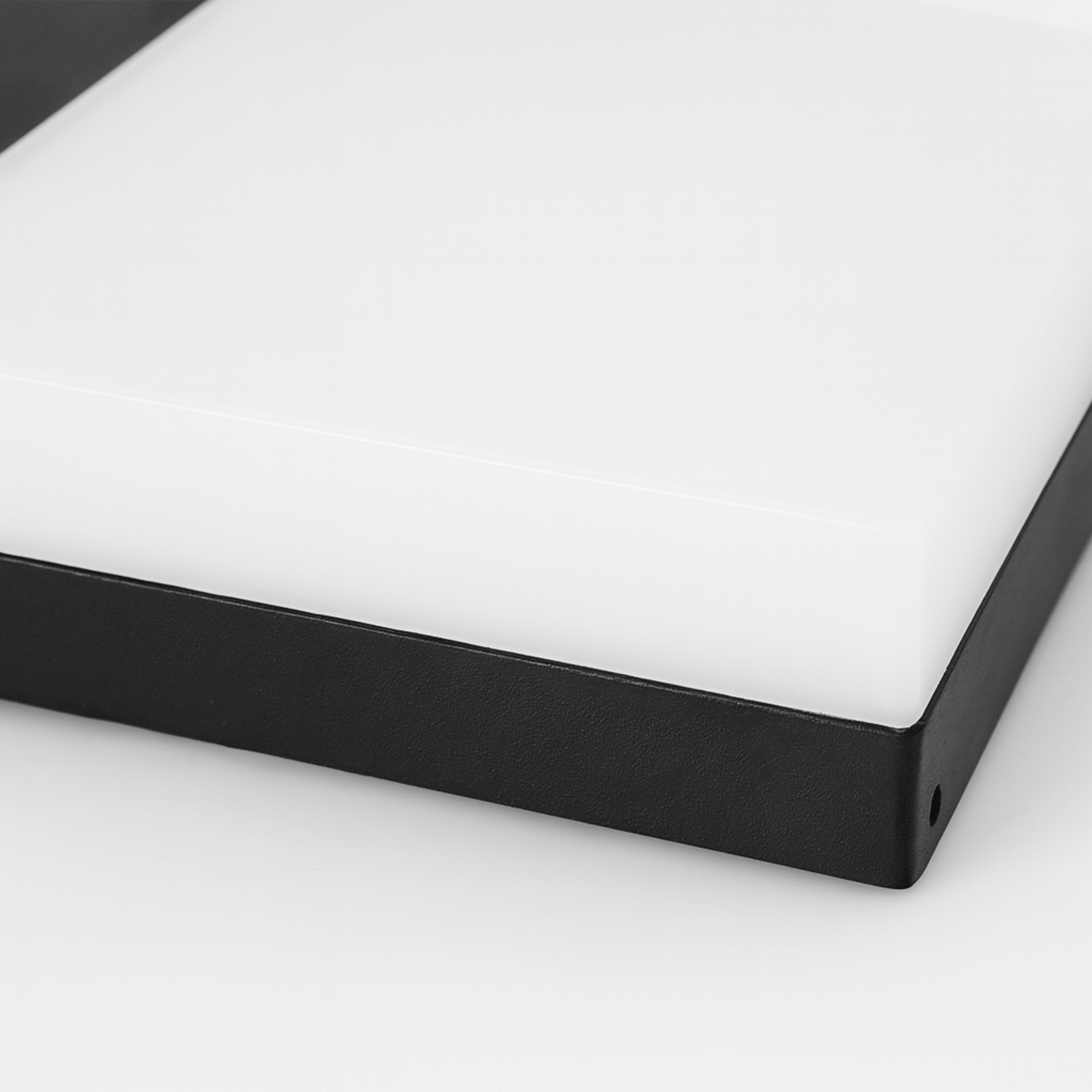 Close-up of a black frame corner on a white background