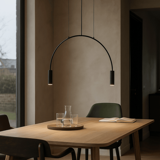 Modern dining room with a wooden table, chairs, and a hanging black arch light.
