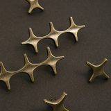 Bronze star-shaped metal components on a dark background