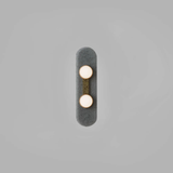 Two bulb sconce with brass mount on dark raindrop textured backplate