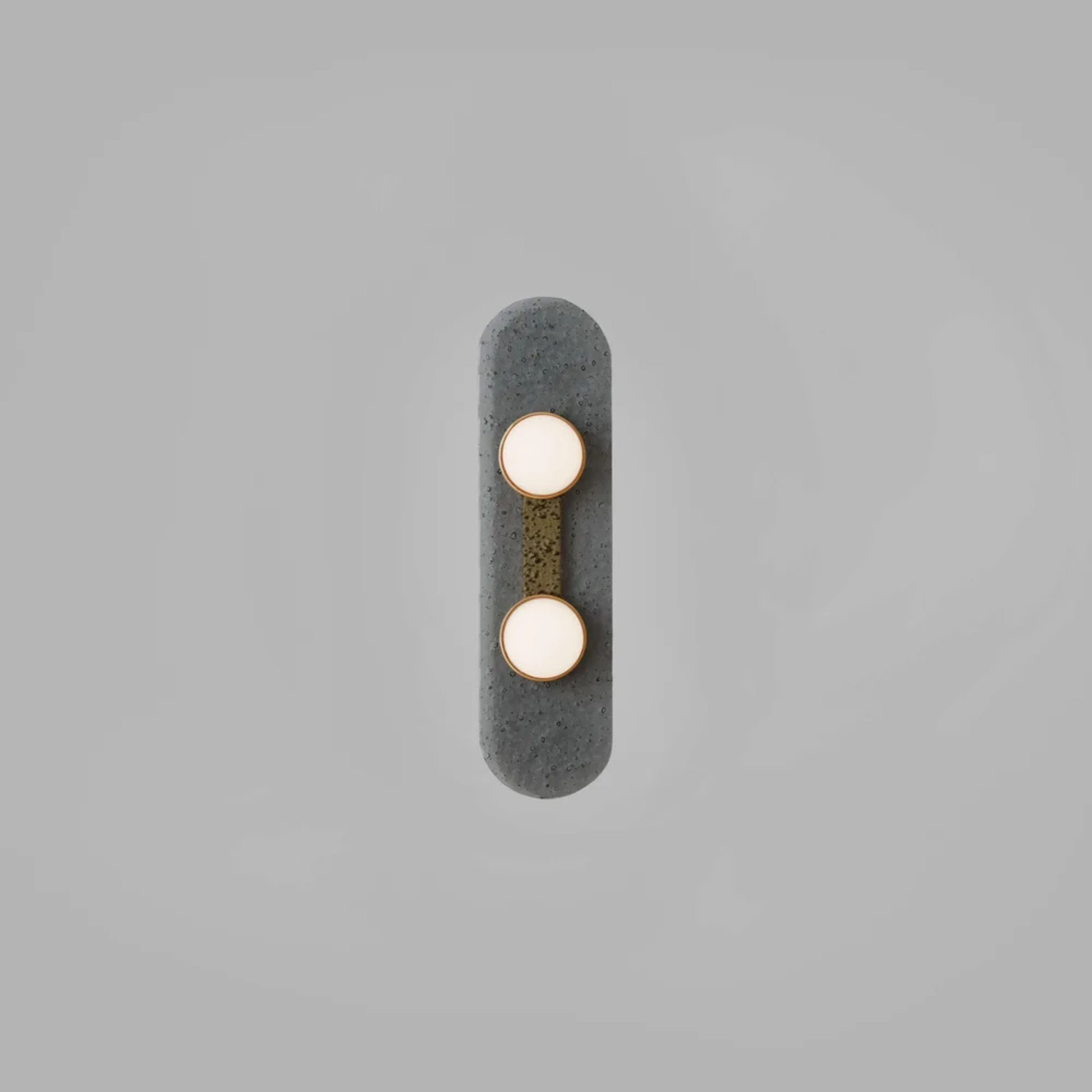 Two bulb sconce with brass mount on dark raindrop textured backplate