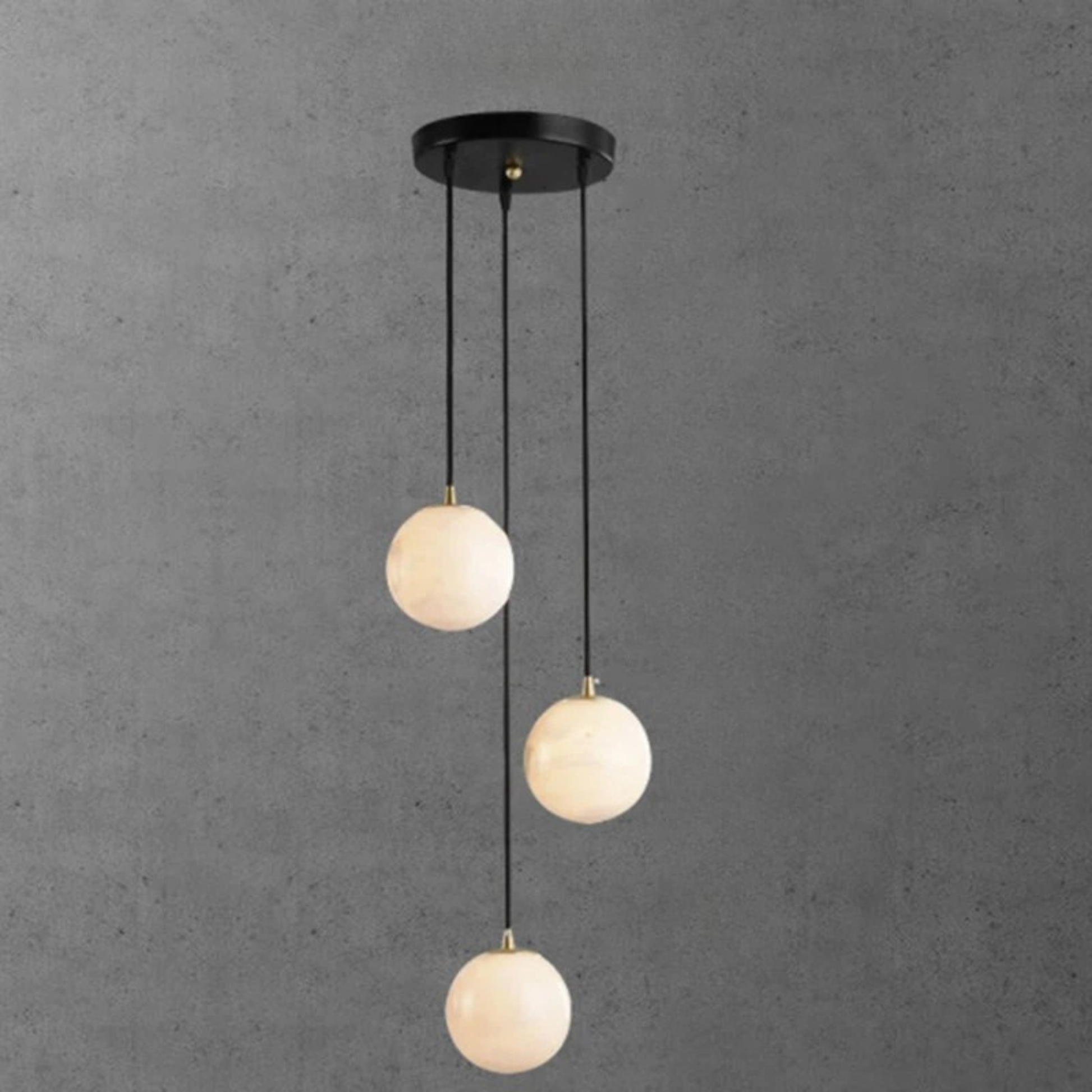 A cascading cluster of warm white globe pendant lights hanging from a black circular ceiling base.