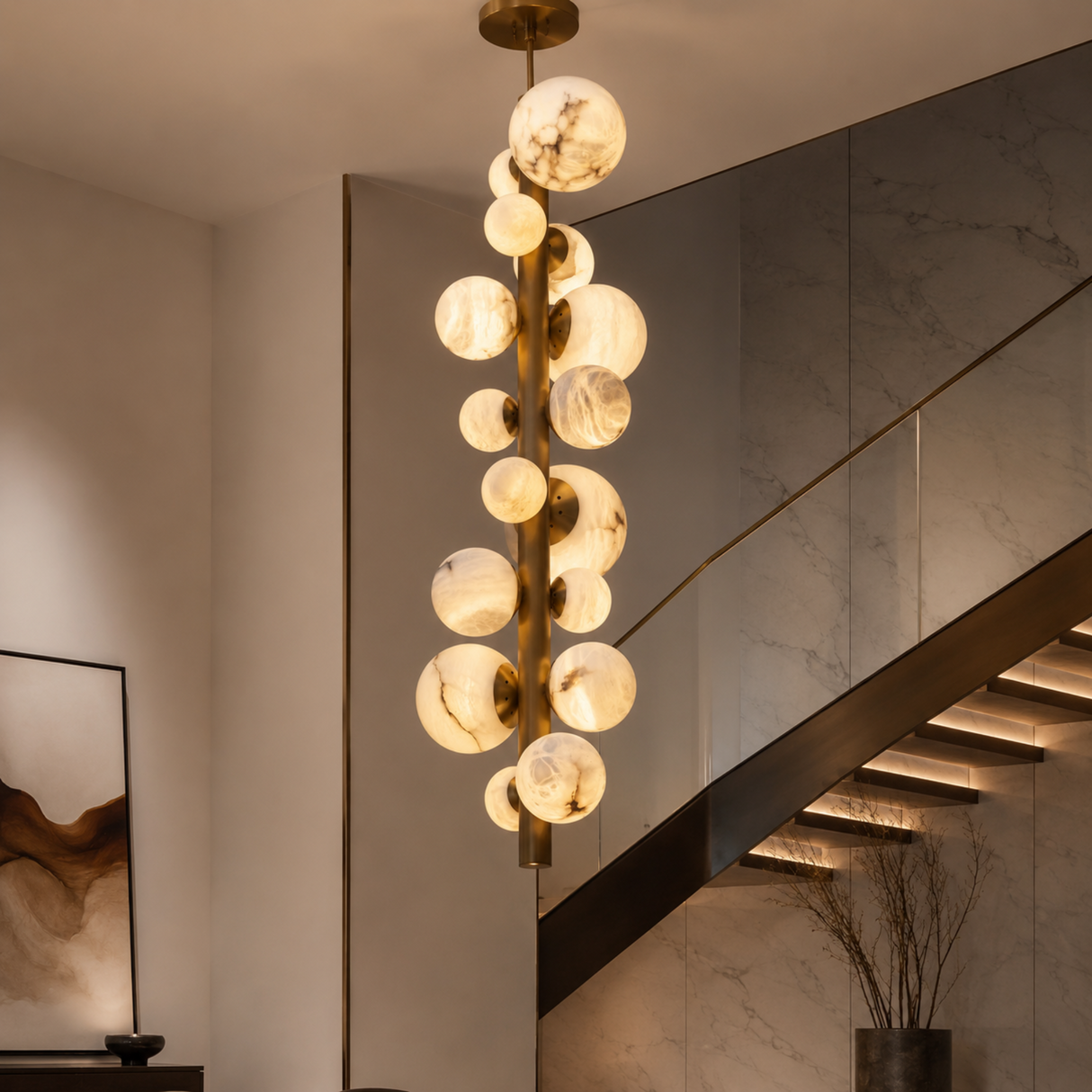 Modern chandelier hanging above a staircase in a stylish interior setting.