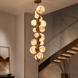 Modern chandelier hanging above a staircase in a stylish interior setting.