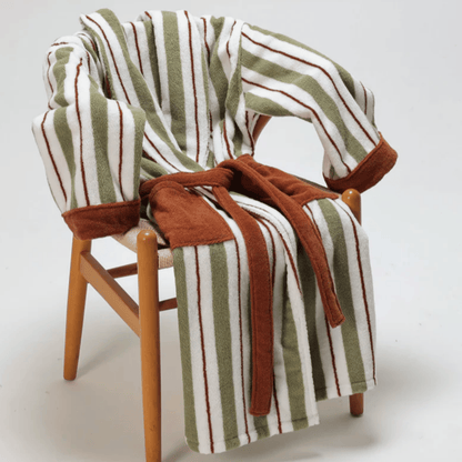 Striped robe draped over a wooden chair on a white background