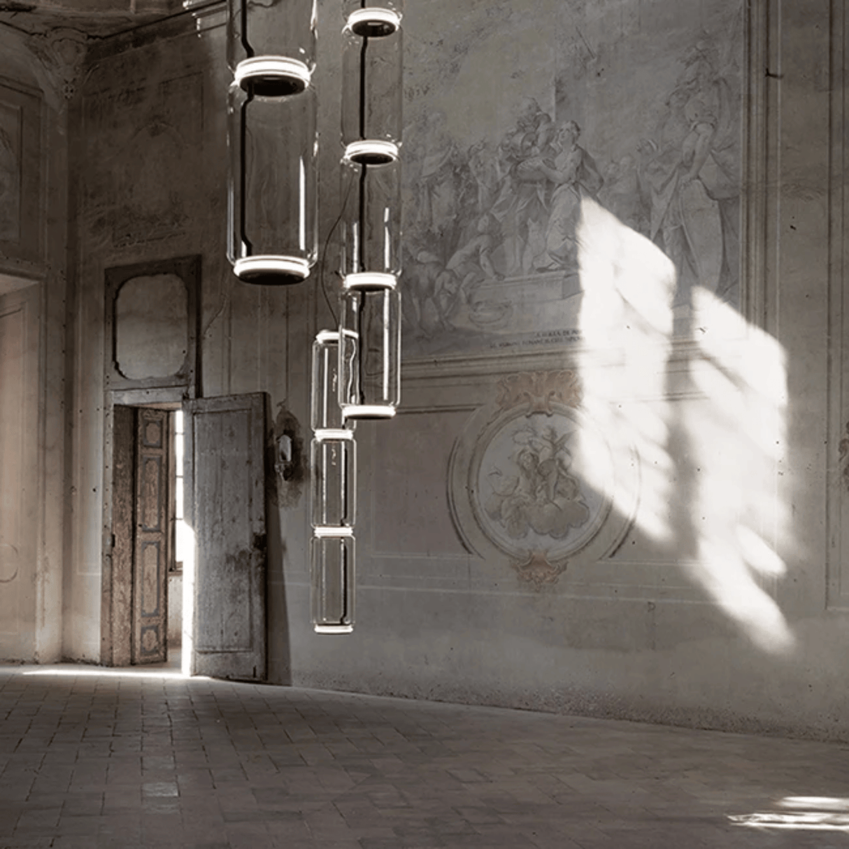 Modern chandelier hanging in a room with classical architecture