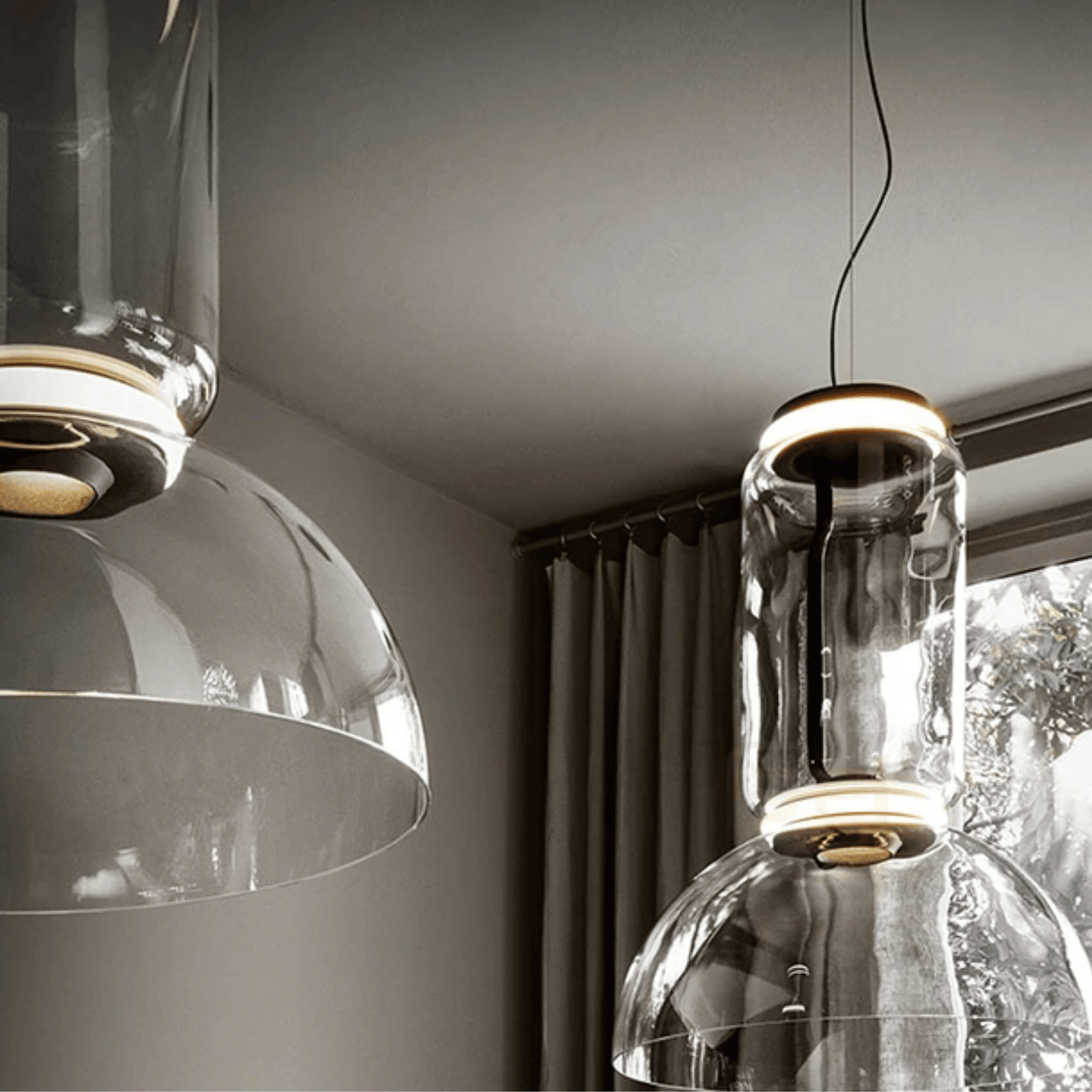 Modern pendant lights hanging in a room with neutral decor