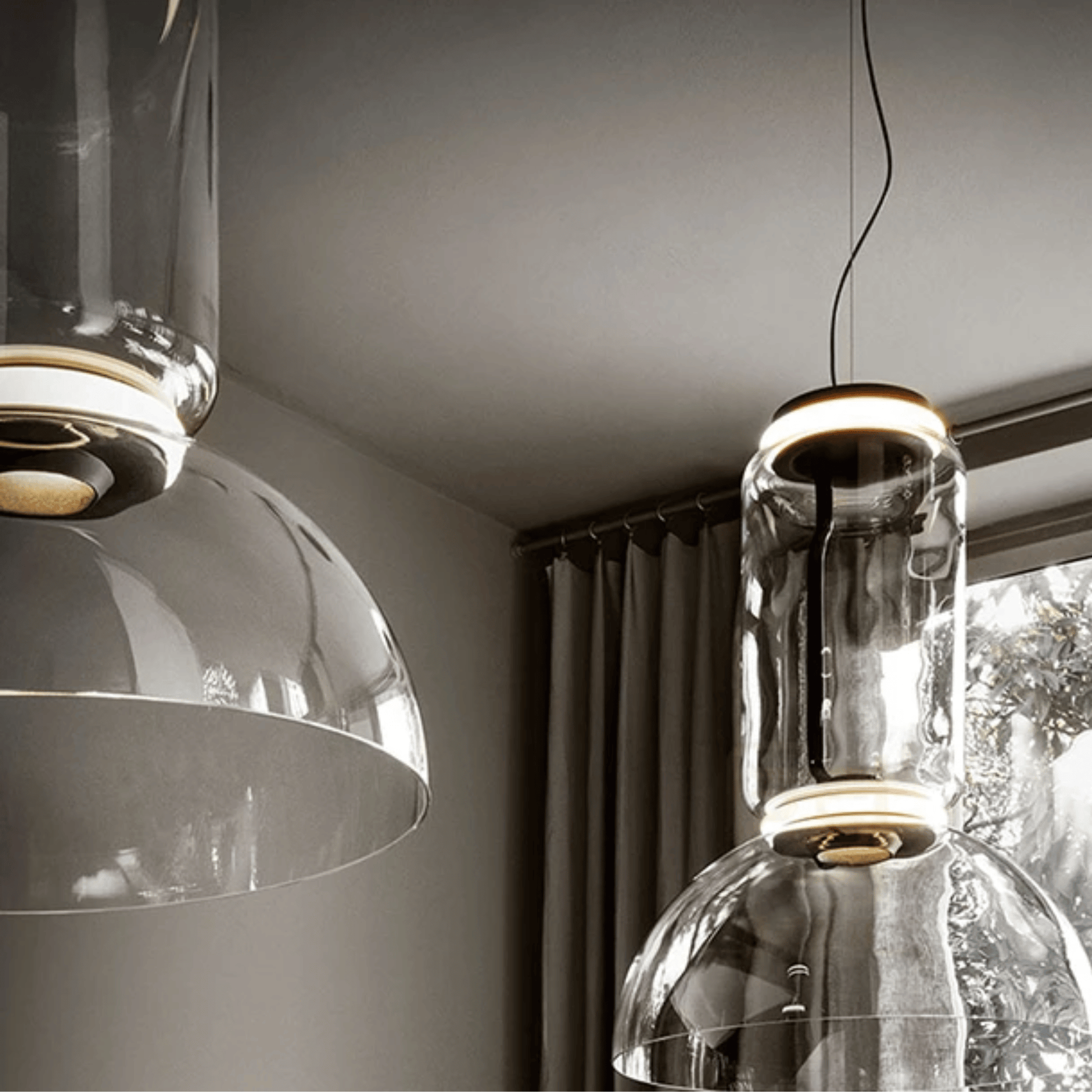 Modern pendant lights hanging in a room with neutral decor