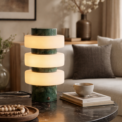 Modern table lamp with stacked cylindrical design on a living room table.