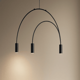 Modern black pendant light with three curved arms on a beige background