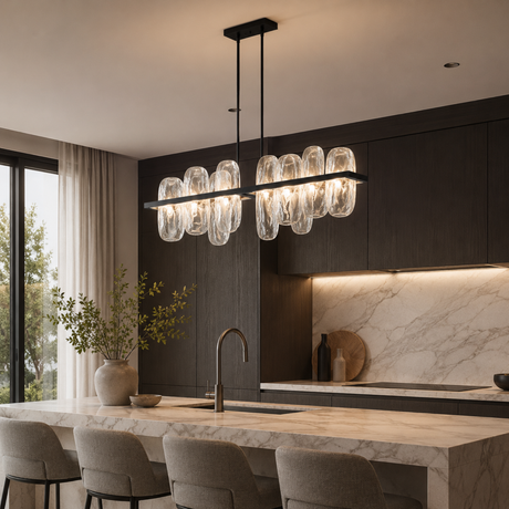 Modern kitchen with a chandelier, marble countertop, and dark cabinets.