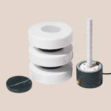 Marble-like cylindrical objects with a central core on a beige background