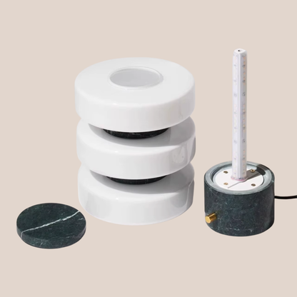 Marble-like cylindrical objects with a central core on a beige background