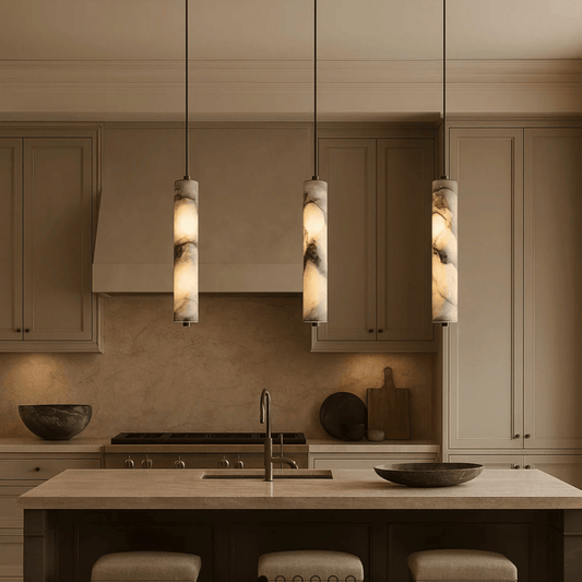 Modern kitchen with pendant lights, stovetop, and countertops.