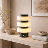 Modern table lamp with marble design on a wooden surface in a home setting