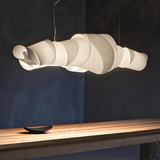 Modern pendant light fixture on a wooden surface with a dark background