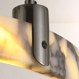 Decorative wall light fixture with marble-like glass shade and metallic finish.