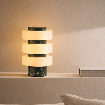 Marble-patterned table lamp on a shelf with a neutral background