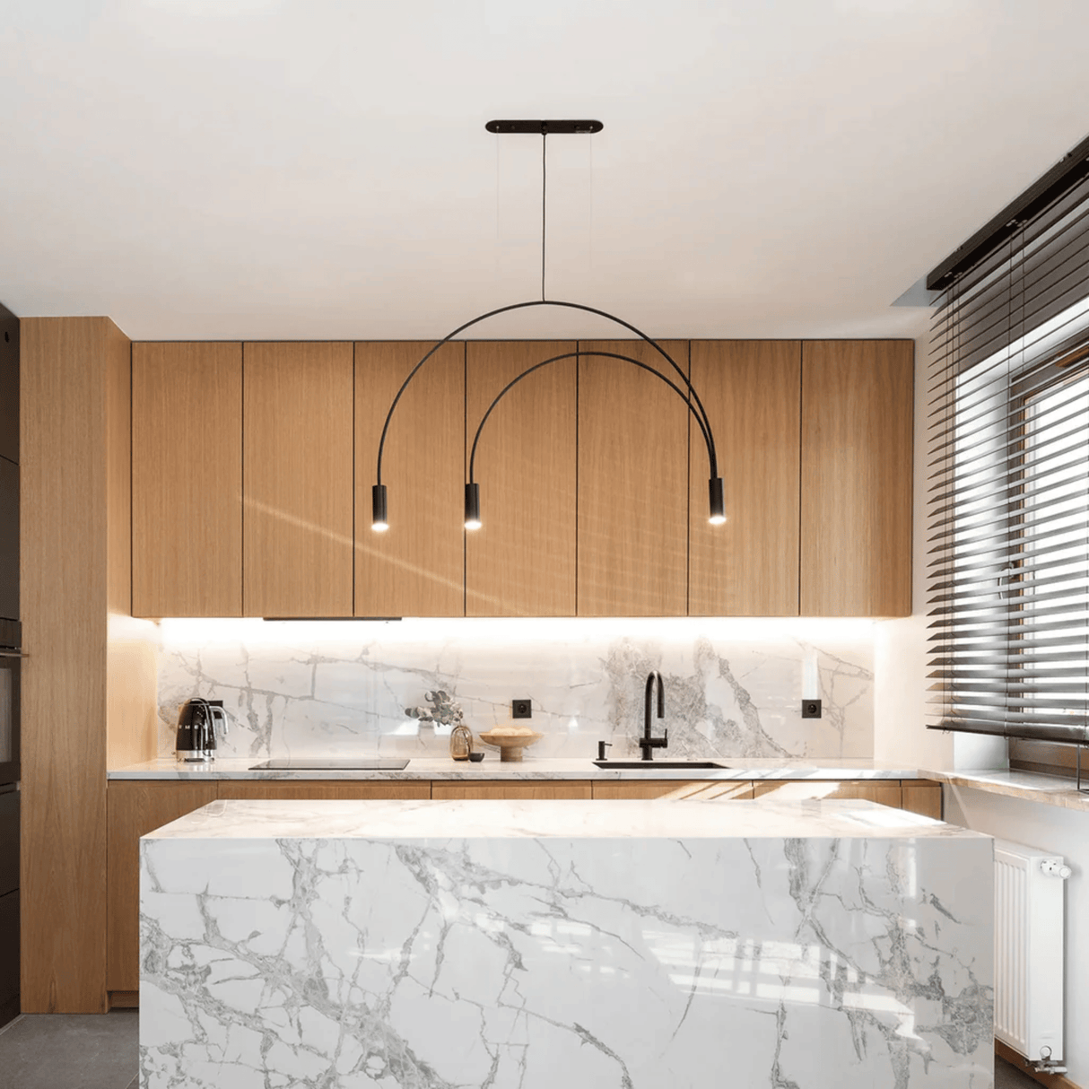 Modern kitchen with marble island and wooden cabinets